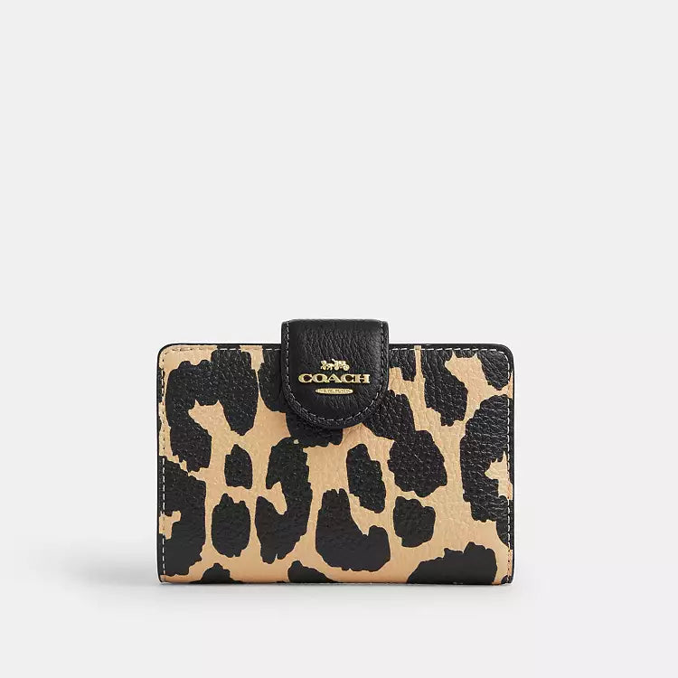 Coach medium corner zip wallet with leopard print in gold, featuring a compact design and gold zipper details.