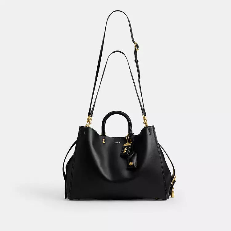 Black leather Coach Rogue Bag 40 crossbody bag with CCX21 logo from The Tiny Bag, showing front view with adjustable strap.