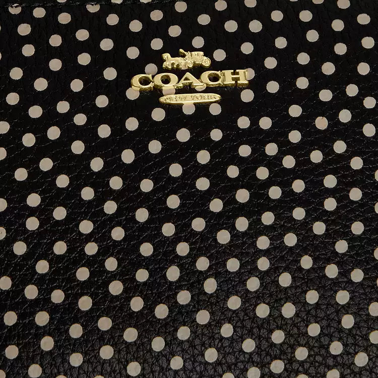 Black Coach Nolita 19 shoulder bag with spot print and pebble leather, featuring refined craftsmanship and compact design.