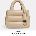 Coach Nappa leather Mini Pillow Tote Bag in ivory, stylish small handbag with soft pillow-like design and top handles.