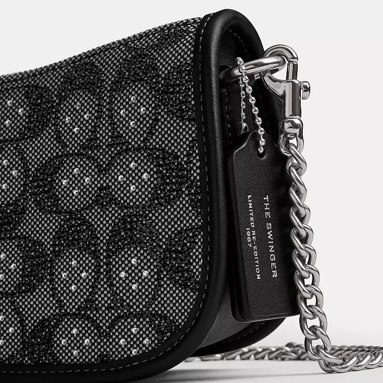 Coach Swinger 20 shoulder bag with chain in black crystal signature jacquard fabric, compact and stylish accessory.