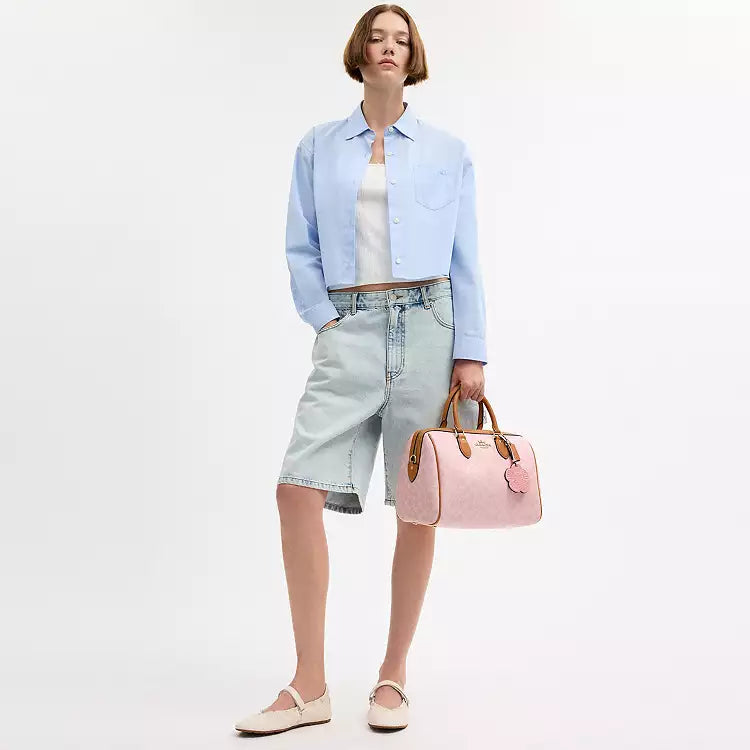 Coach Rowan large signature canvas shoulder bag with charms in powder pink, featuring a spacious design and stylish accents.
