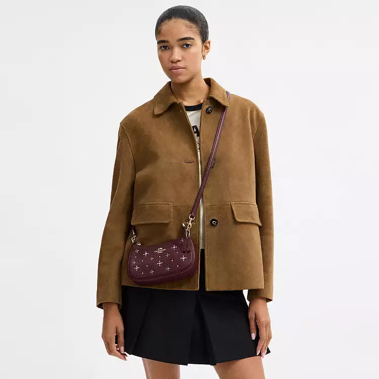 Dark wine leather Coach CCE43 Teri Mini Crossbody Shoulder Bag with crystal embellishments, featuring a compact design and adjustable strap.