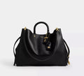 Black leather Coach Rogue Bag 40 crossbody bag with signature CC logo from The Tiny Bag, showcasing its sleek design.