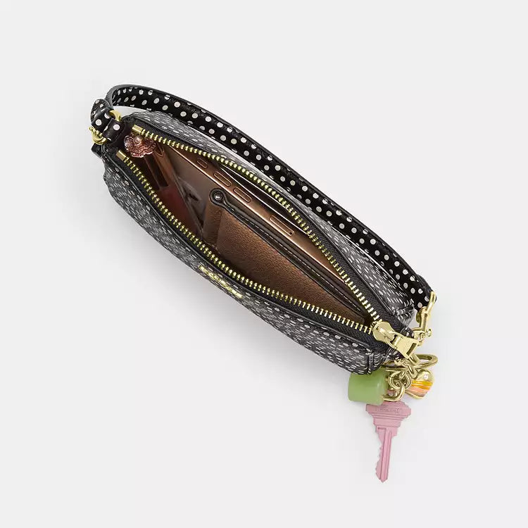 Black Coach Nolita 19 shoulder bag with spot print and pebble leather, featuring a refined design and compact shape.