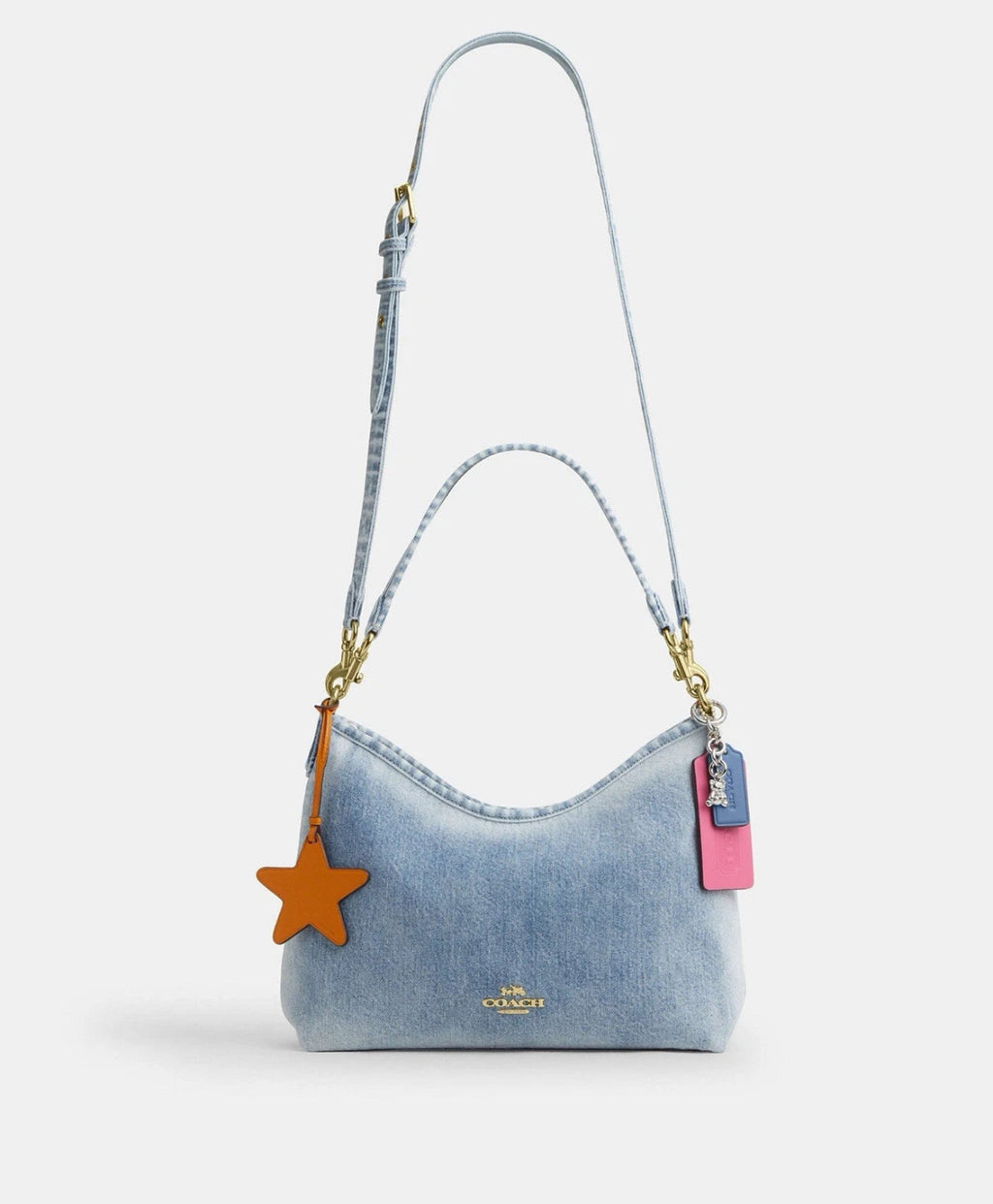 Light indigo Coach CEF26 Laurel shoulder bag in loved denim with charms, featuring a stylish and versatile design from The Tiny Bag.