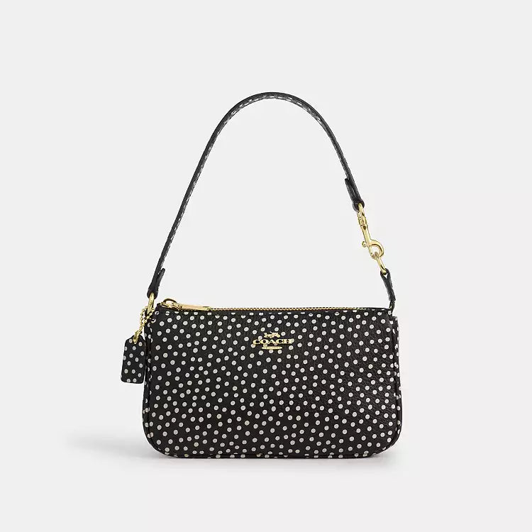 Black Coach Nolita 19 shoulder bag with spot print design in refined pebble leather, featuring the Tiny Bag branding.