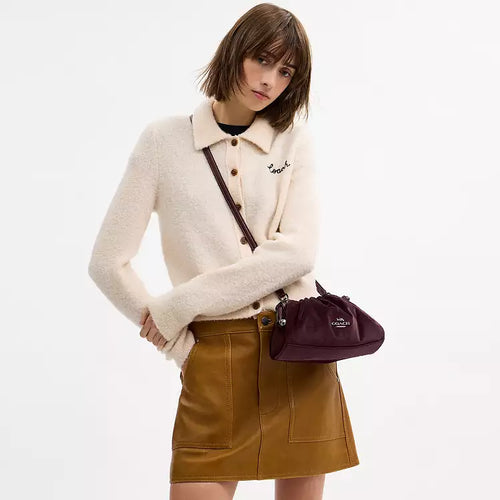 Coach Faye Shoulder Crossbody Bag in luxurious velvet burgundy, featuring a compact design and adjustable strap.