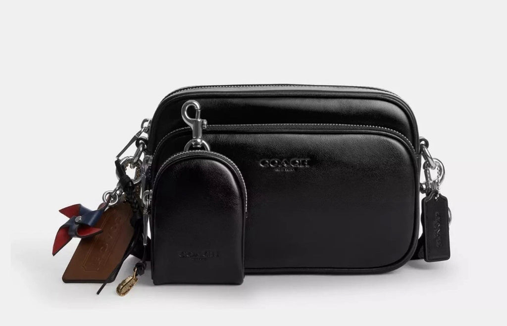 Coach Finlay crossbody bag charm with shiny silver and black smooth leather, attached to a small crossbody bag by The Tiny Bag.