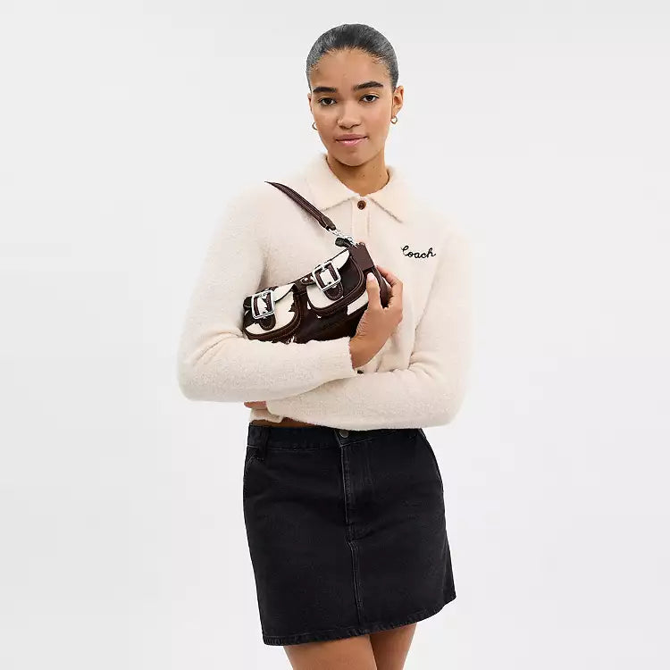 Coach Ashton shoulder bag with cow print haircalf leather and multicolor cow pattern, stylish and textured accessory.