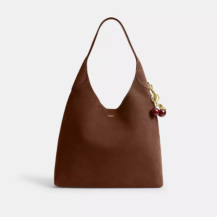 Coach CW636 Suede Brooklyn 39 shoulder bag in warm brown with brass hardware, featuring a stylish suede finish and compact design.