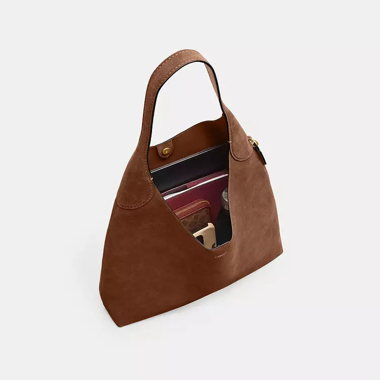 Coach CW636 Suede Brooklyn 39 shoulder bag in warm brown with brass hardware, featuring a sleek, compact design and suede finish.