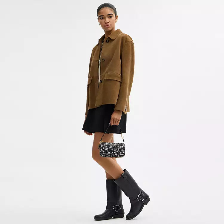 Black Coach Nolita 19 shoulder bag with spot print in refined pebble leather, featuring a compact, stylish design from The Tiny Bag.