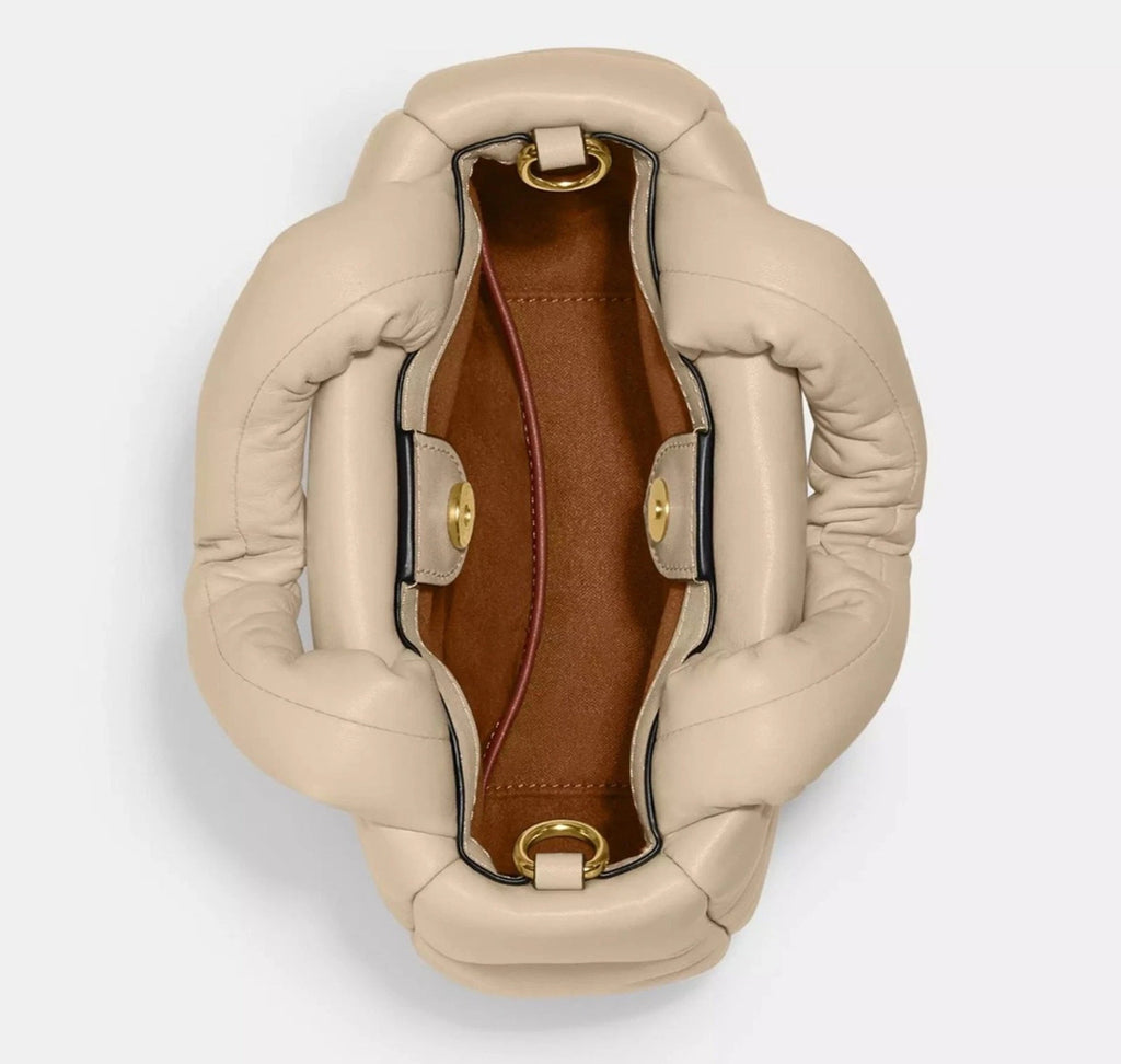 Coach Nappa leather Mini Pillow Tote Bag in ivory with structured design and top handles, showcasing its elegant craftsmanship.