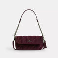 Coach Hailey Flap Bag shoulder bag in burgundy velvet with quilting, organic cotton details, and a stylish flap design.