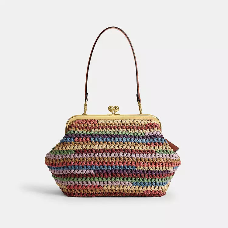 Multicolor straw shoulder bag by The Tiny Bag with a large kisslock clasp and spacious interior, designed for stylish everyday use.