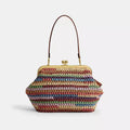 Multicolor straw shoulder bag by The Tiny Bag with a large kisslock clasp and spacious interior, designed for stylish everyday use.