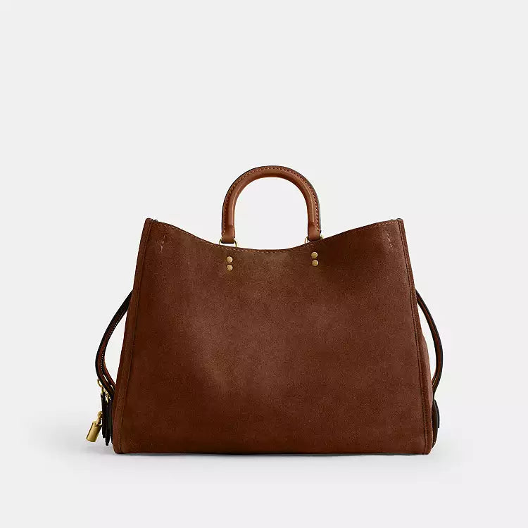 Coach Rogue 40 suede leather shoulder bag in brown, featuring signature CC logo and sleek design from The Tiny Bag.