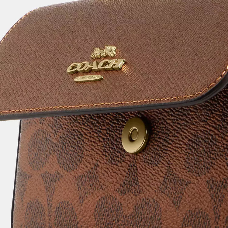 Coach Mini Josie top handle crossbody bag in signature canvas with brown and copper accents, featuring a compact, stylish design.