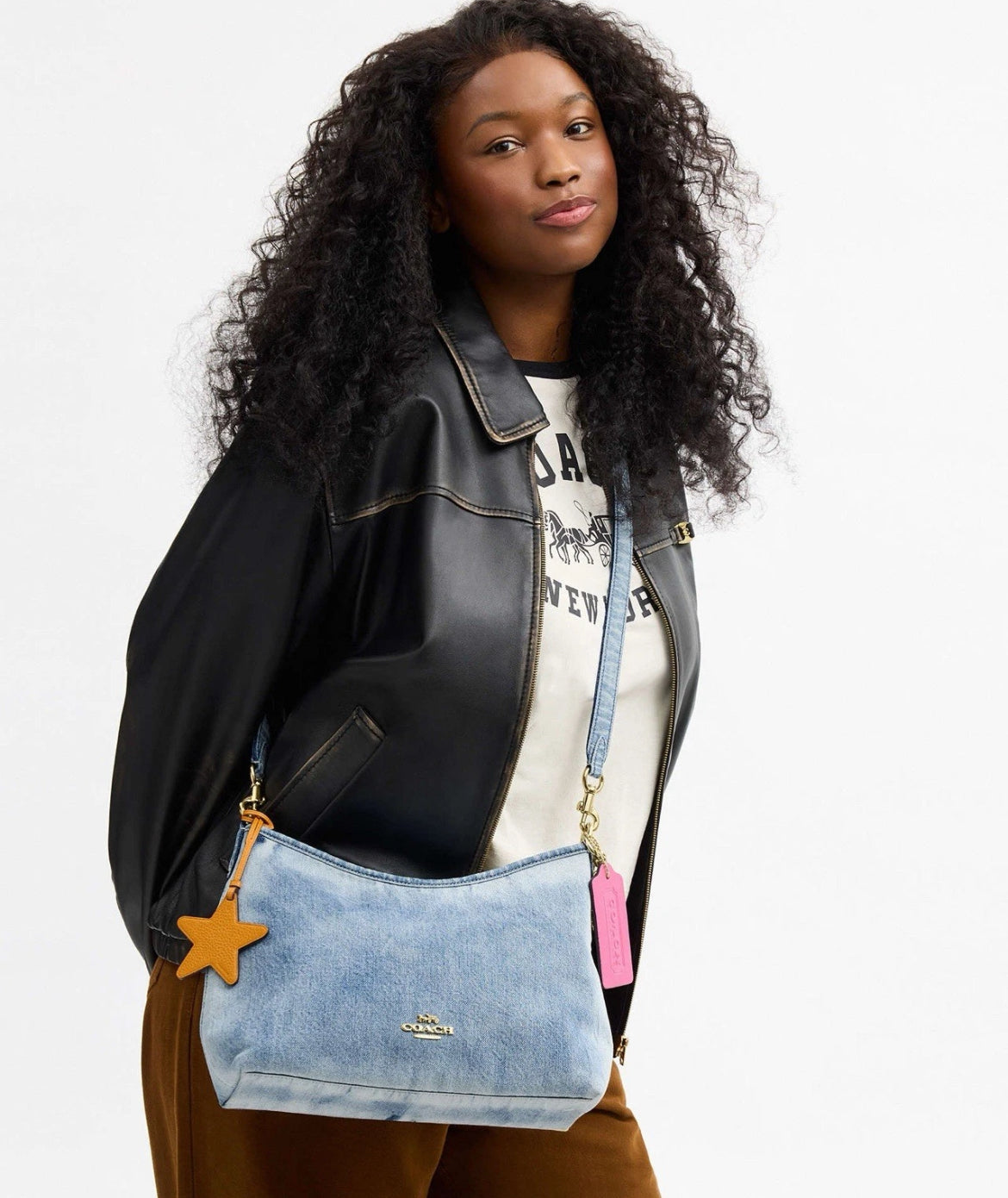 Coach CEF26 Laurel shoulder bag in loved denim with charms, light indigo color, featuring a small, stylish design.