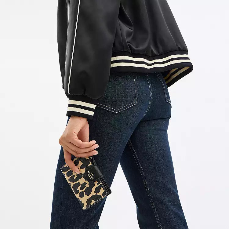 Coach Medium Corner Zip Wallet with leopard print and gold accents, featuring a compact design and zip closure.