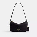 Coach Kailey leather shoulder bag with pebbled leather, gold hardware, and black accents.