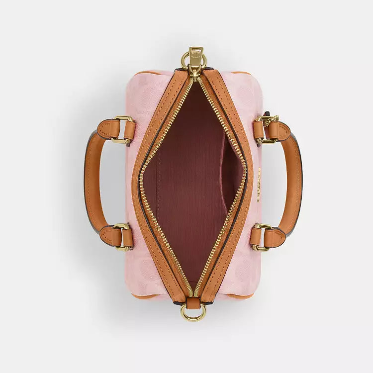Coach Mini Rowan crossbody bag in signature leather with charms, in powder pink, by The Tiny Bag.