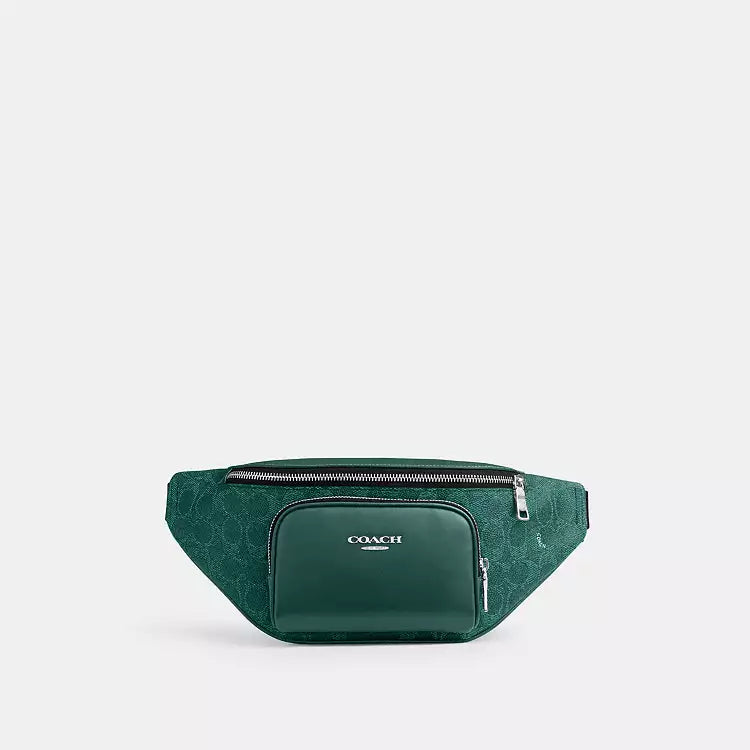 The Tiny Bag COACH Racer small belt bag in signature canvas with silver and sea green colors, featuring a crossbody strap.