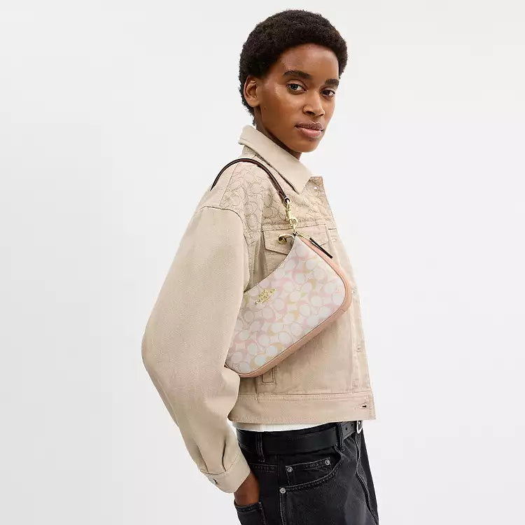 Coach Teri shoulder bag in signature canvas with gold, chalk, and pink accents, featuring the iconic design and stylish details.