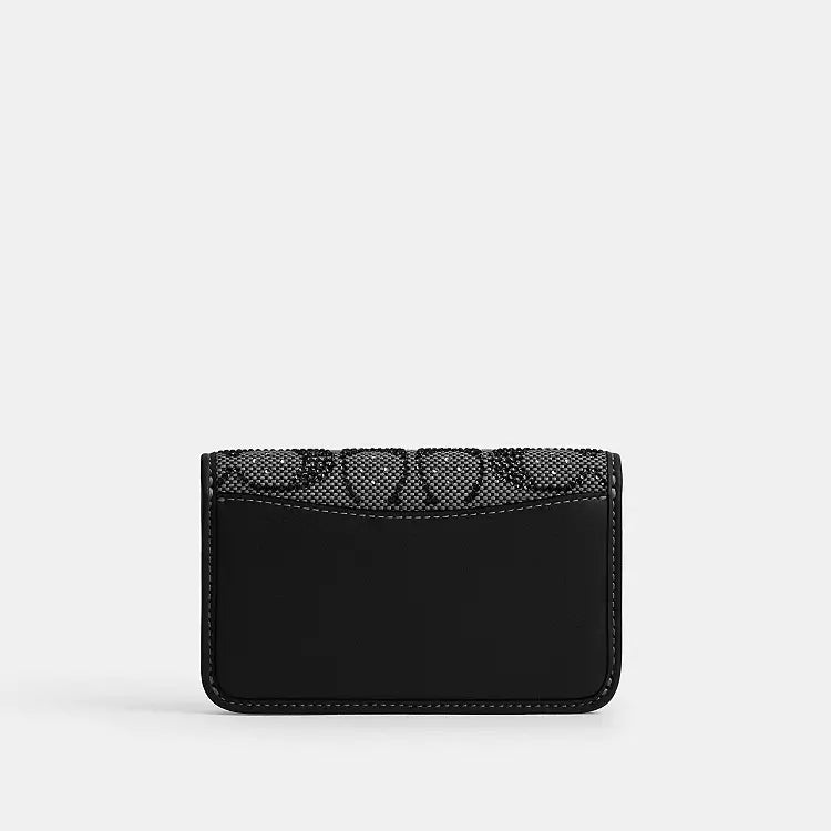 Coach Essential Slim Card Case wallet in black Crystal Signature Jacquard fabric, compact and stylish for everyday use.