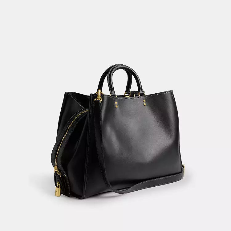 Black leather Coach Rogue Bag 40 crossbody with signature CC logo from The Tiny Bag, featuring a sleek, compact design.