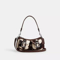 Coach Ashton shoulder bag with cow print haircalf leather, featuring the iconic CCC logo in a multi-color cow design.