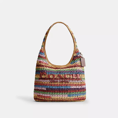 Coach Brooklyn large straw shoulder bag with multi-colored straw design and brass accents, stylish and spacious for everyday use.