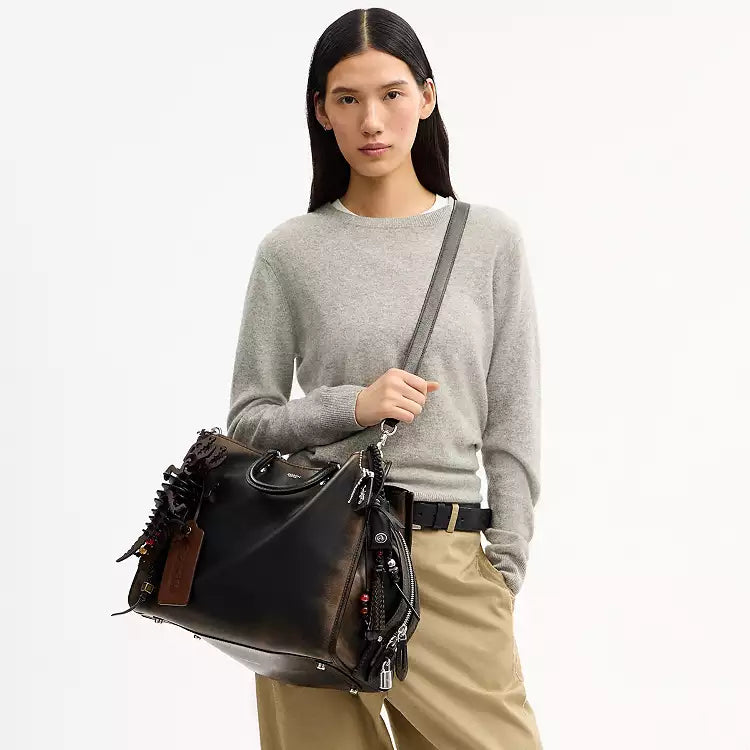 Coach Rogue Bag 40 in loved leather with charms, stylish shoulder bag by The Tiny Bag featuring elegant design and detailed accents.