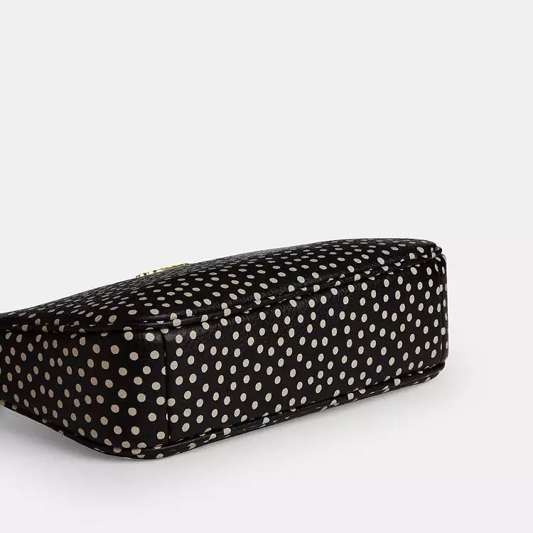 Coach Nolita 19 shoulder bag with spot print design, made from refined pebble leather in black, by The Tiny Bag.