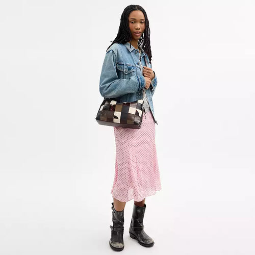 The Tiny Bag Coach Coachtopia Alter/Ego slouchy shoulder bag in maple multi cow leather with a relaxed, spacious design.
