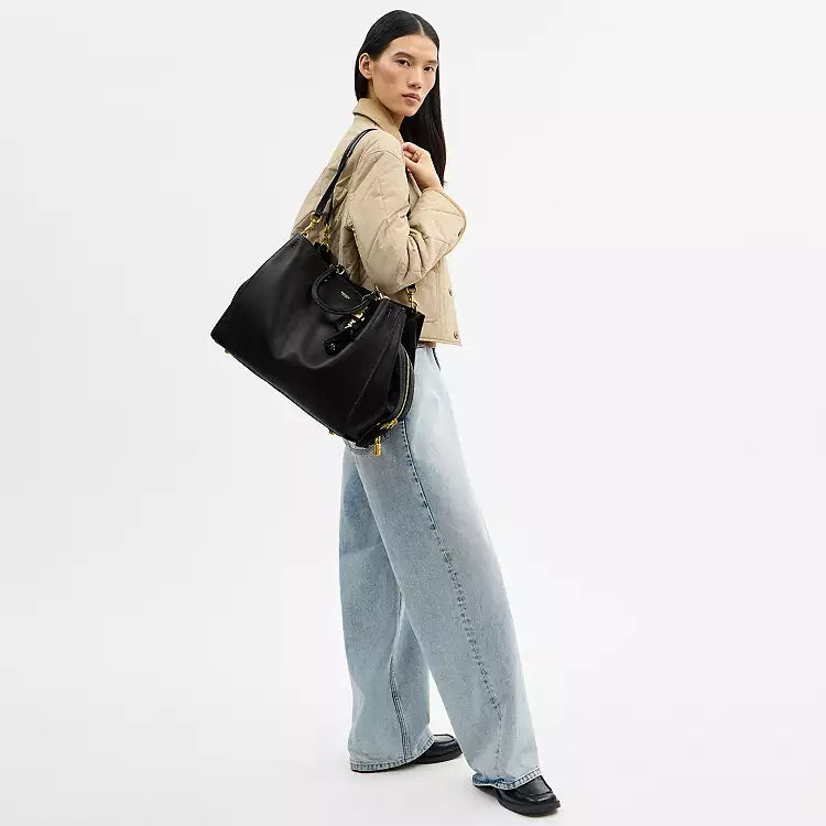 Black leather Coach Rogue Bag 40 crossbody bag with CCX21 logo, featuring sleek design and adjustable strap.