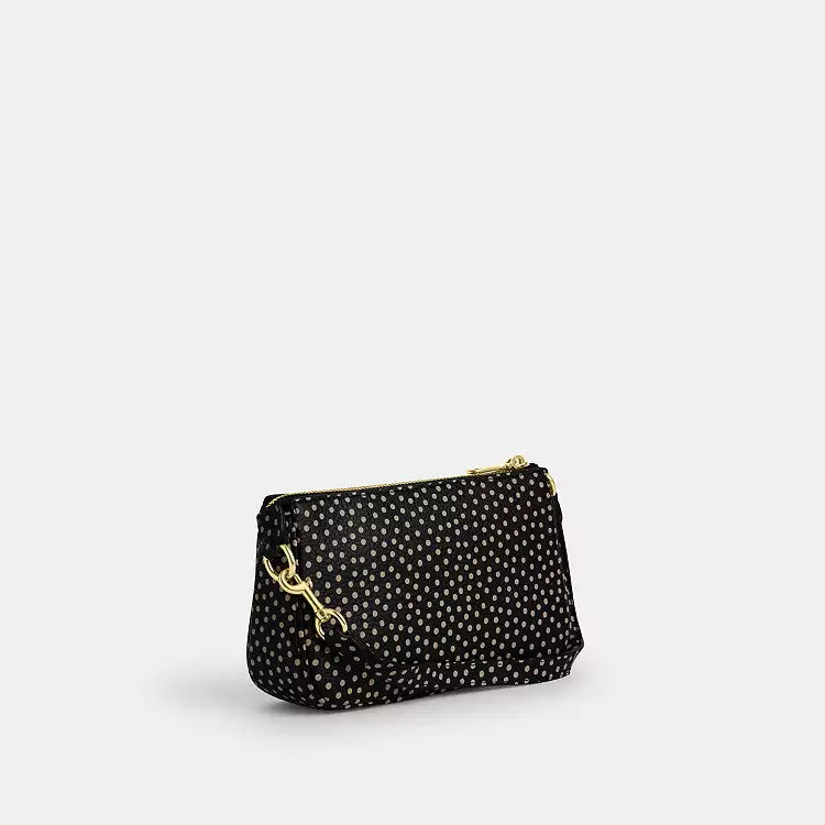 Coach Nolita 19 shoulder bag in black pebble leather with spot print, from The Tiny Bag collection.