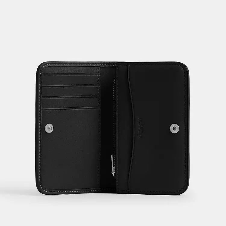 Coach Essential Slim Card Case wallet in black Crystal Signature Jacquard fabric, compact design with card slots and signature pattern.