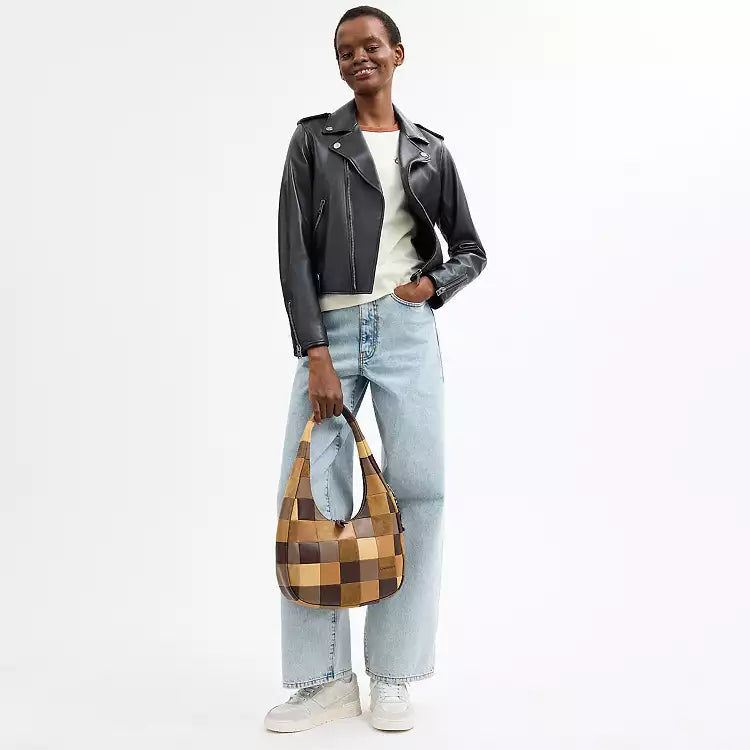 Coach Alter Ego Crescent Shoulder Bag in checkerboard pattern with tan and brown leather, featuring signature CC logo and adjustable strap.