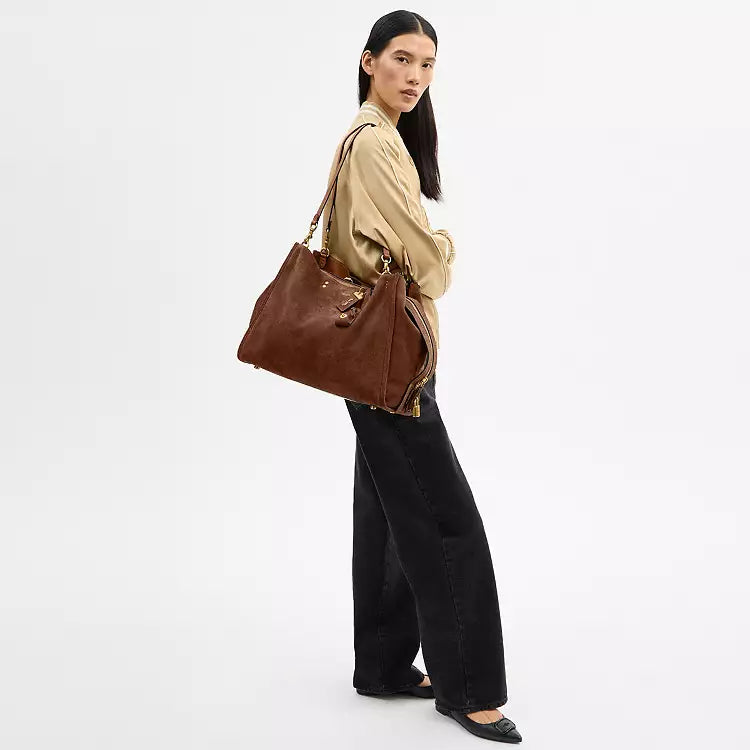 Brown Coach Rogue 40 suede leather shoulder bag with CCX66 logo, featuring a stylish and spacious design.