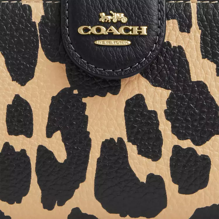 Coach medium corner zip wallet with leopard print and gold accents, featuring a compact design and signature leather details.