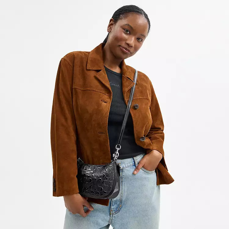 Coach Teri shoulder bag in signature leather with heart charm, featuring a sleek design and subtle branding detail.