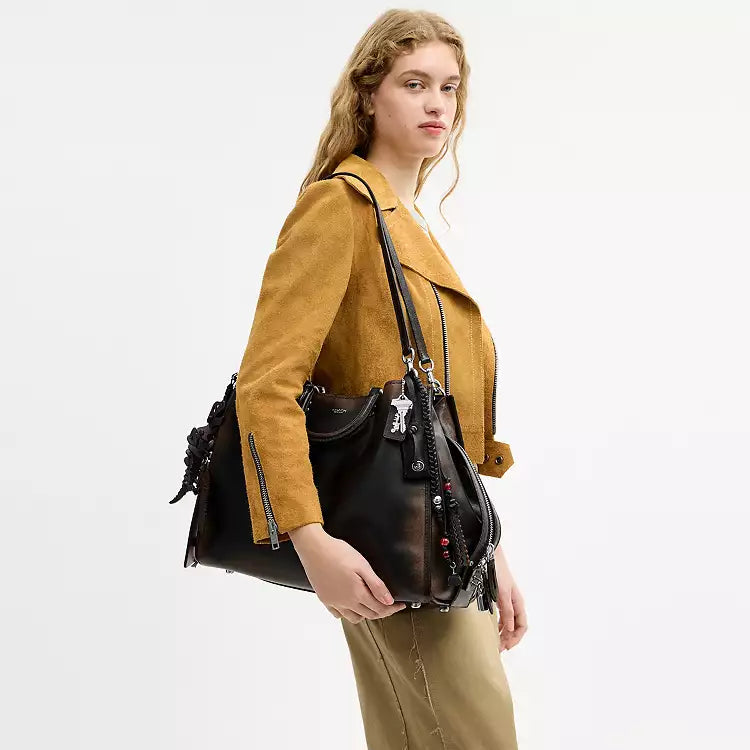 Coach Rogue Shoulder Bag in loved leather with charms, featuring a stylish design and spacious interior from The Tiny Bag.