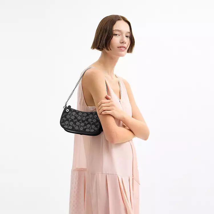 Coach Swinger 20 shoulder bag with chain in black crystal signature jacquard fabric from The Tiny Bag collection.