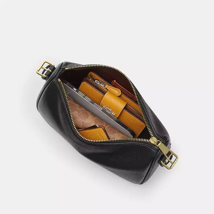 Coach Kailey leather shoulder bag in black pebbled leather with gold accents, featuring a compact, stylish design.