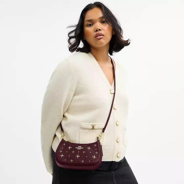 Dark wine leather Coach Teri Mini Crossbody Bag with crystal embellishments, featuring a compact shoulder bag design.