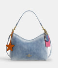 Coach CEF26 Laurel shoulder bag in light indigo denim with charms, featuring a stylish design by The Tiny Bag.