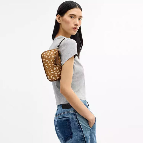Coach Nolita 19 shoulder bag with deer print in brown multi, featuring a compact design and wristlet strap.