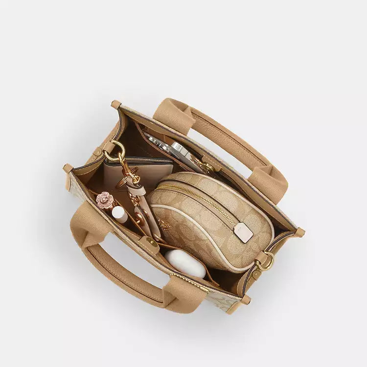 Coach Signature Jacquard Smith Tote bag in light khaki with leather handles and spacious interior for everyday use.